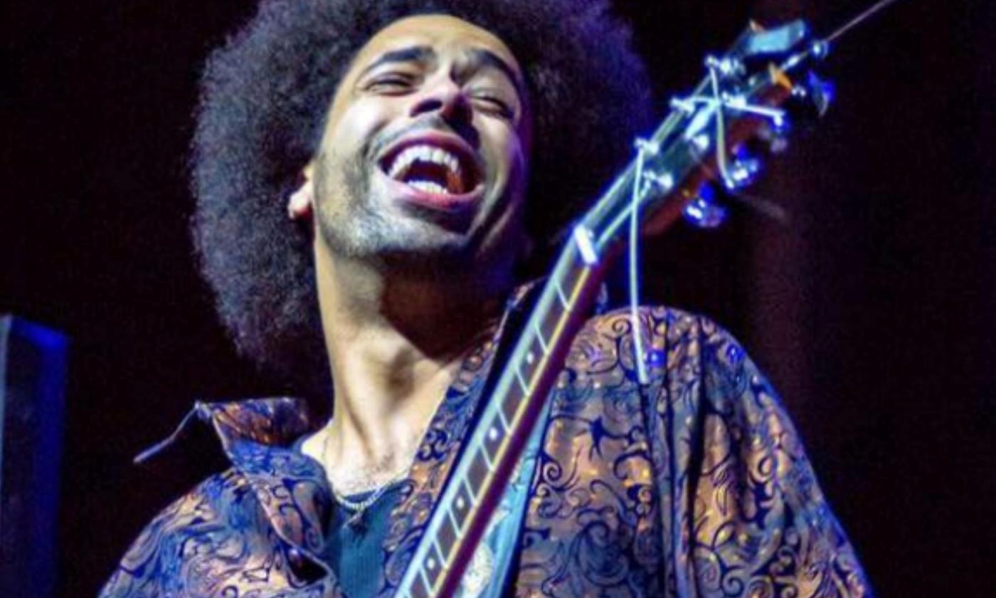 Selwyn Birchwood smiles with his guitar